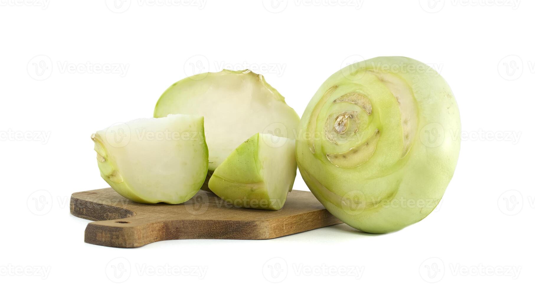Fresh Kohlrabi Whole and Sliced Displayed on Wooden Cutting Board photo