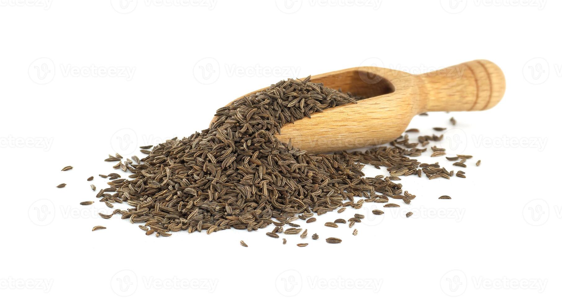 Wooden Scoop Overflowing with Caraway Seeds photo