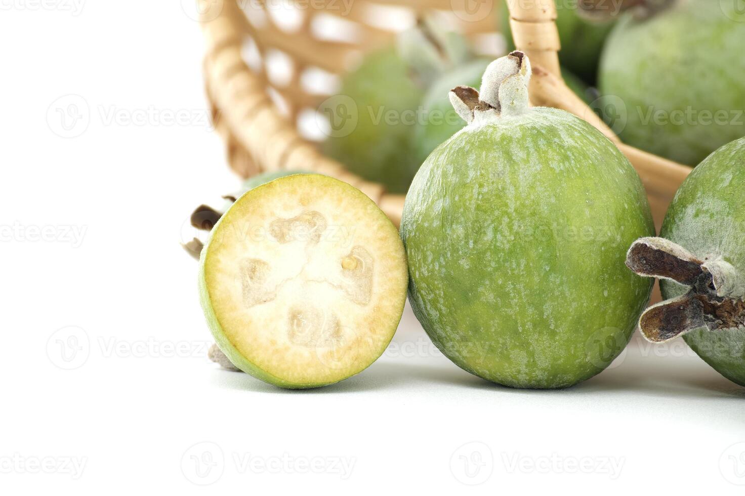 Fresh Green Feijoas on White Background with Basket photo