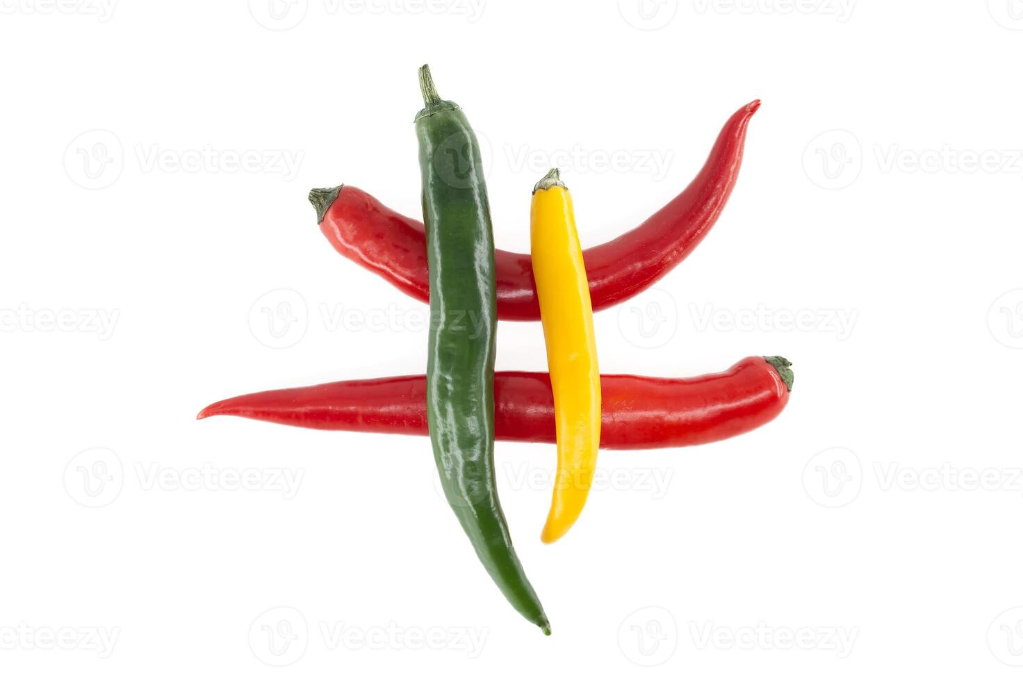 Red, green and yellow chili peppers forming a decorative design photo