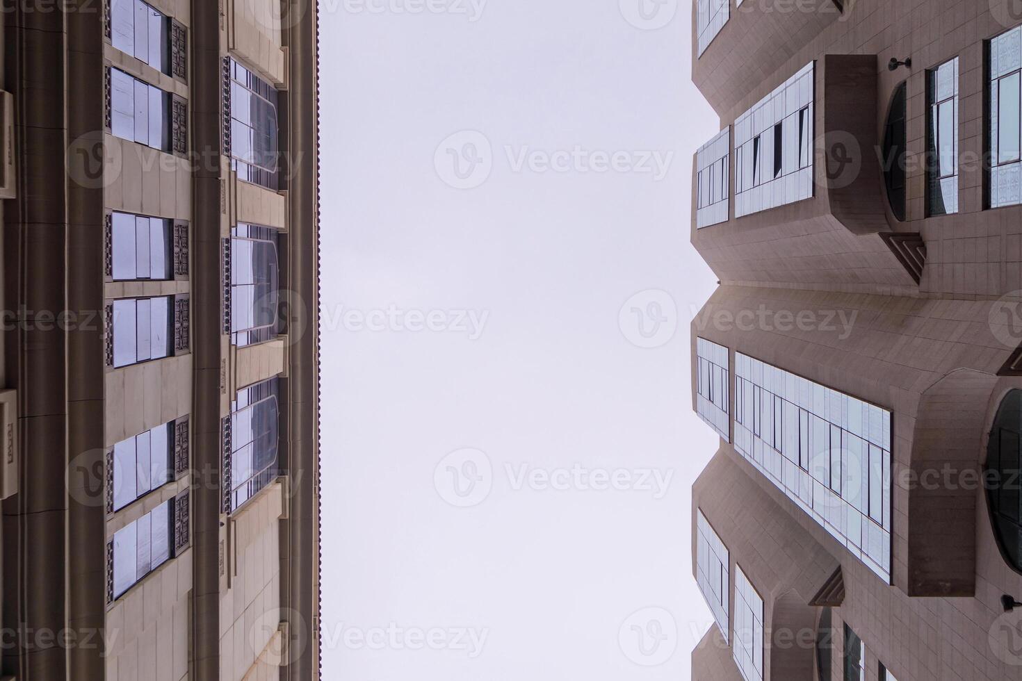 Looking up at the sky between two tall buildings photo