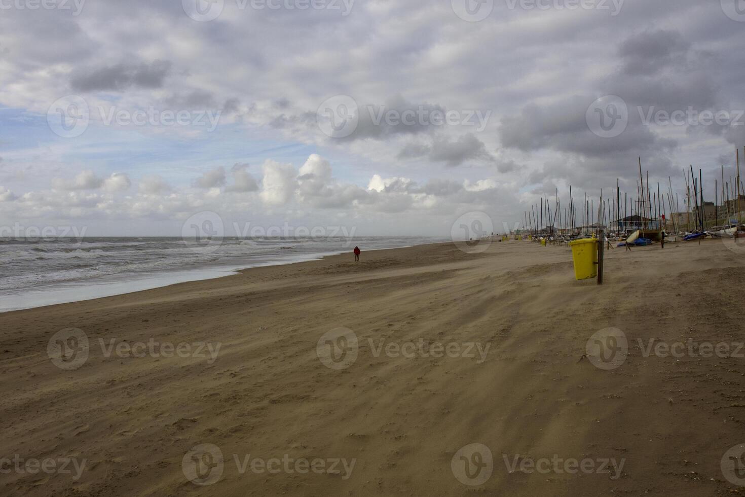 House by the sea. Grey sky, waves and wind photo
