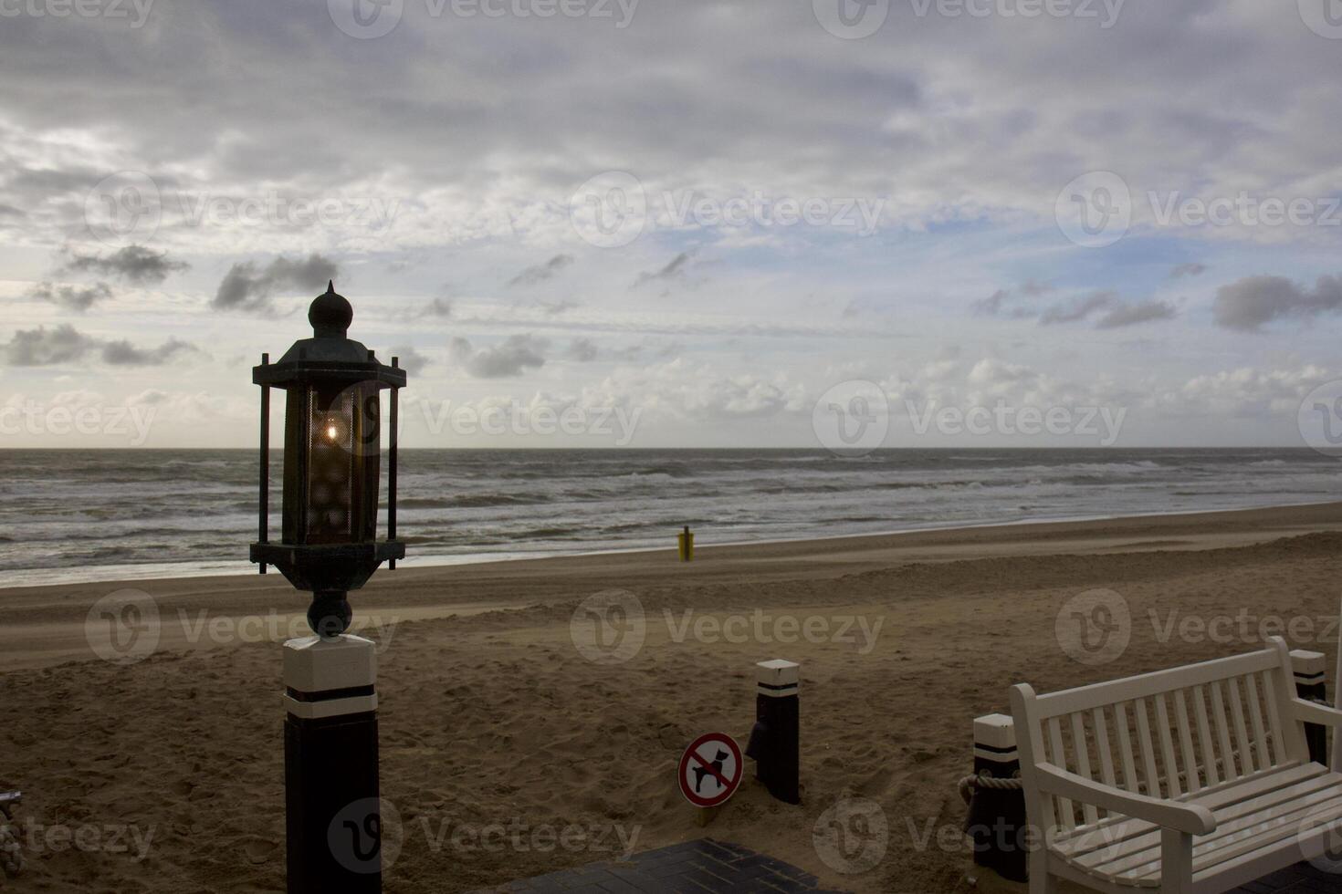 House by the sea. Grey sky, waves and wind photo