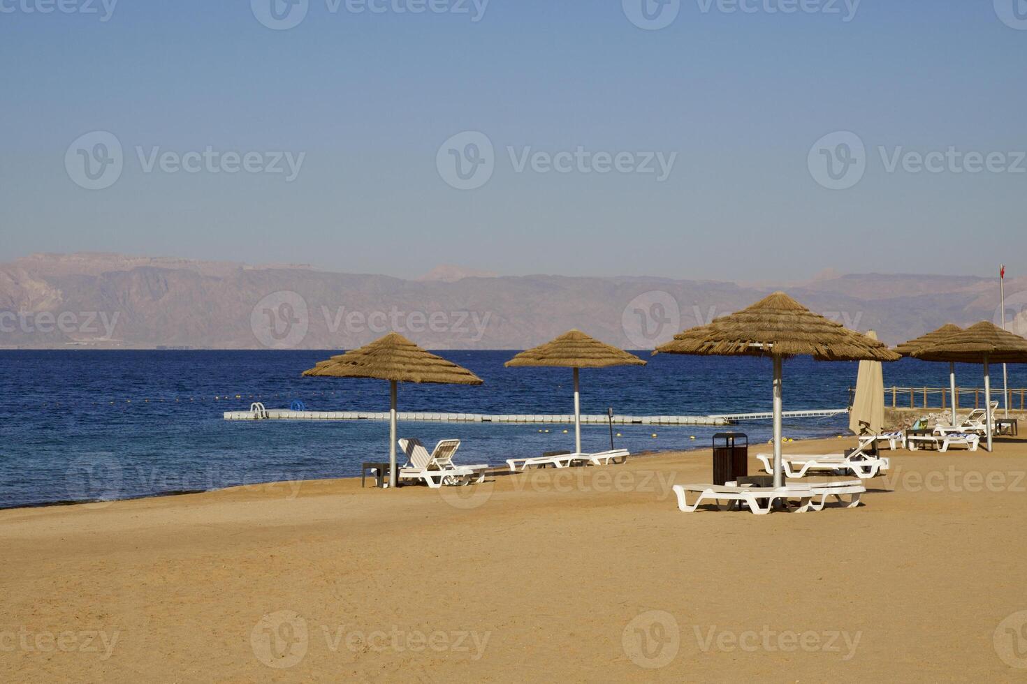 Relax on the beach with umbrellas and sun loungers photo