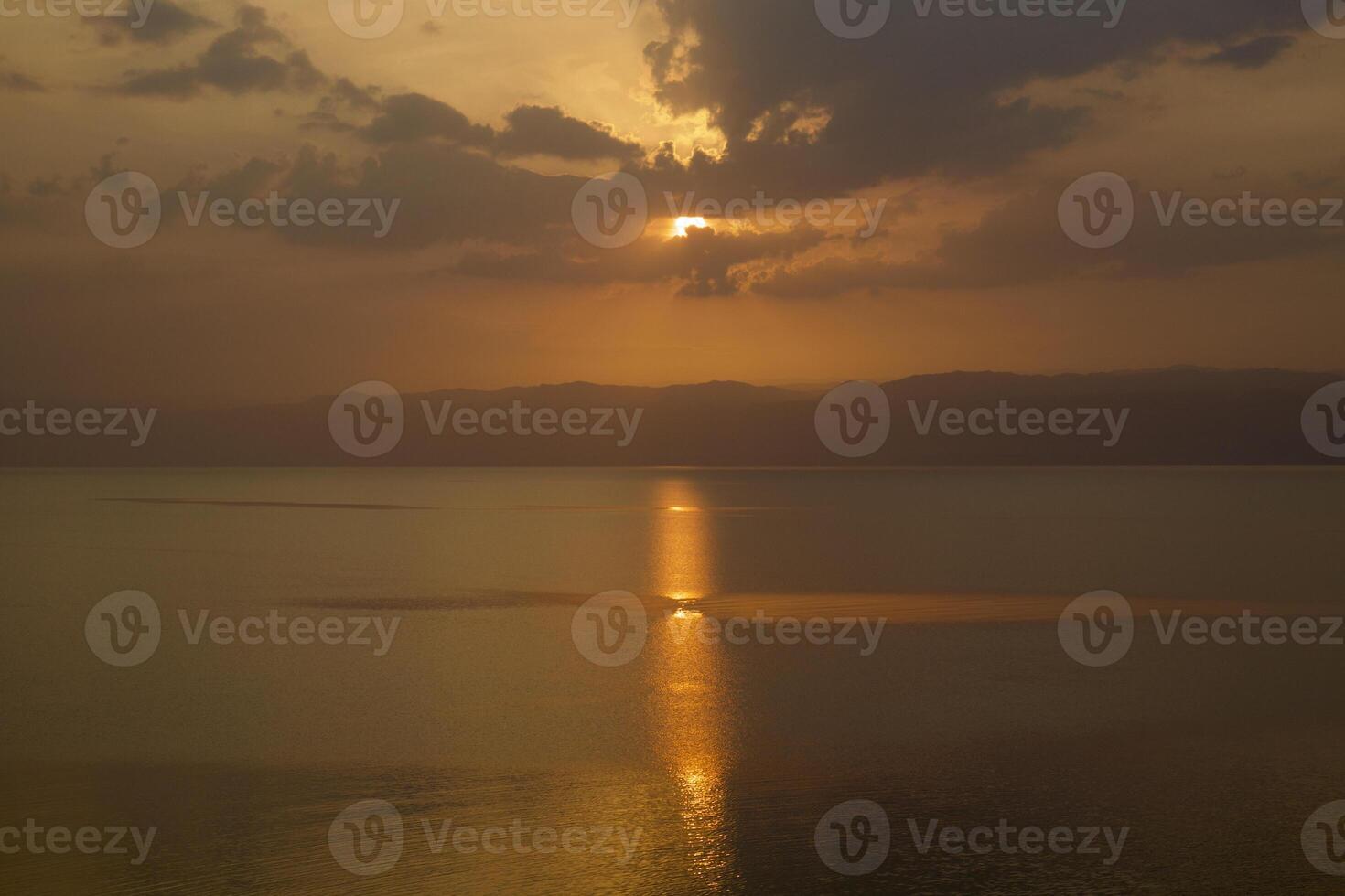 Sea horizon sun goes down photo