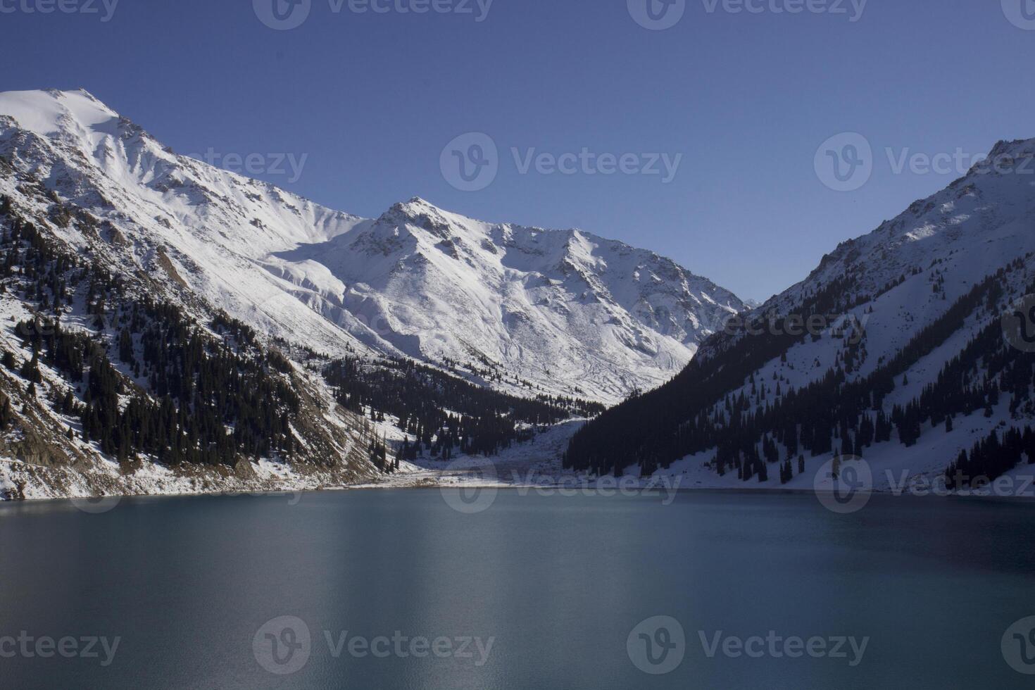 Winter mountain lake surrounded by a mountain rage photo