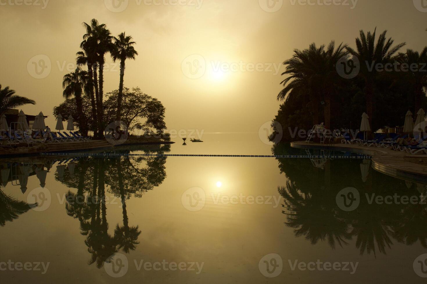 Sea horizon sun goes down photo