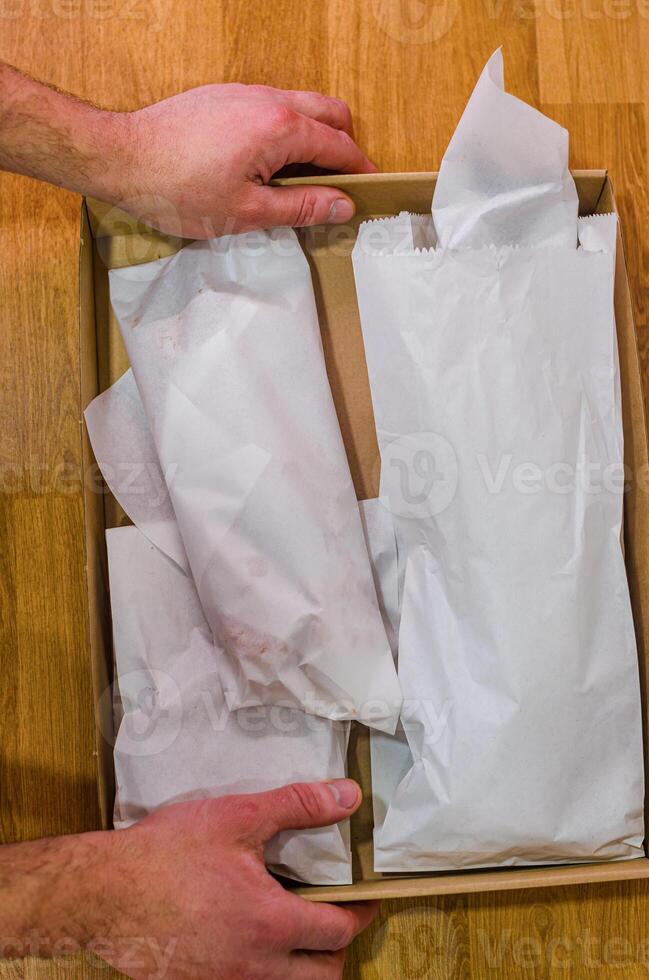 Packed sea food in a Cardboard Box on a Wooden Table. High quality photo