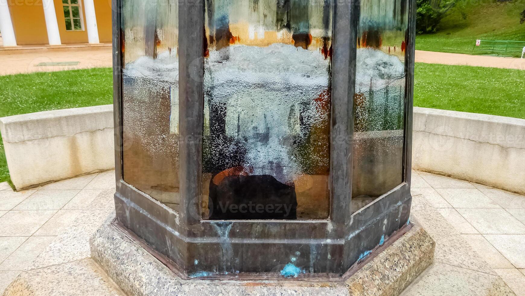 Close-up mineral water spring structure with colorful glass and bubbling water. High quality photo
