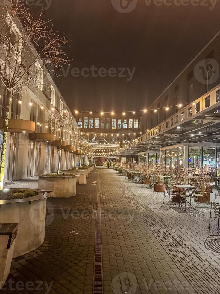 A quiet evening at an outdoor dining area, bathed in soft light. High quality photo