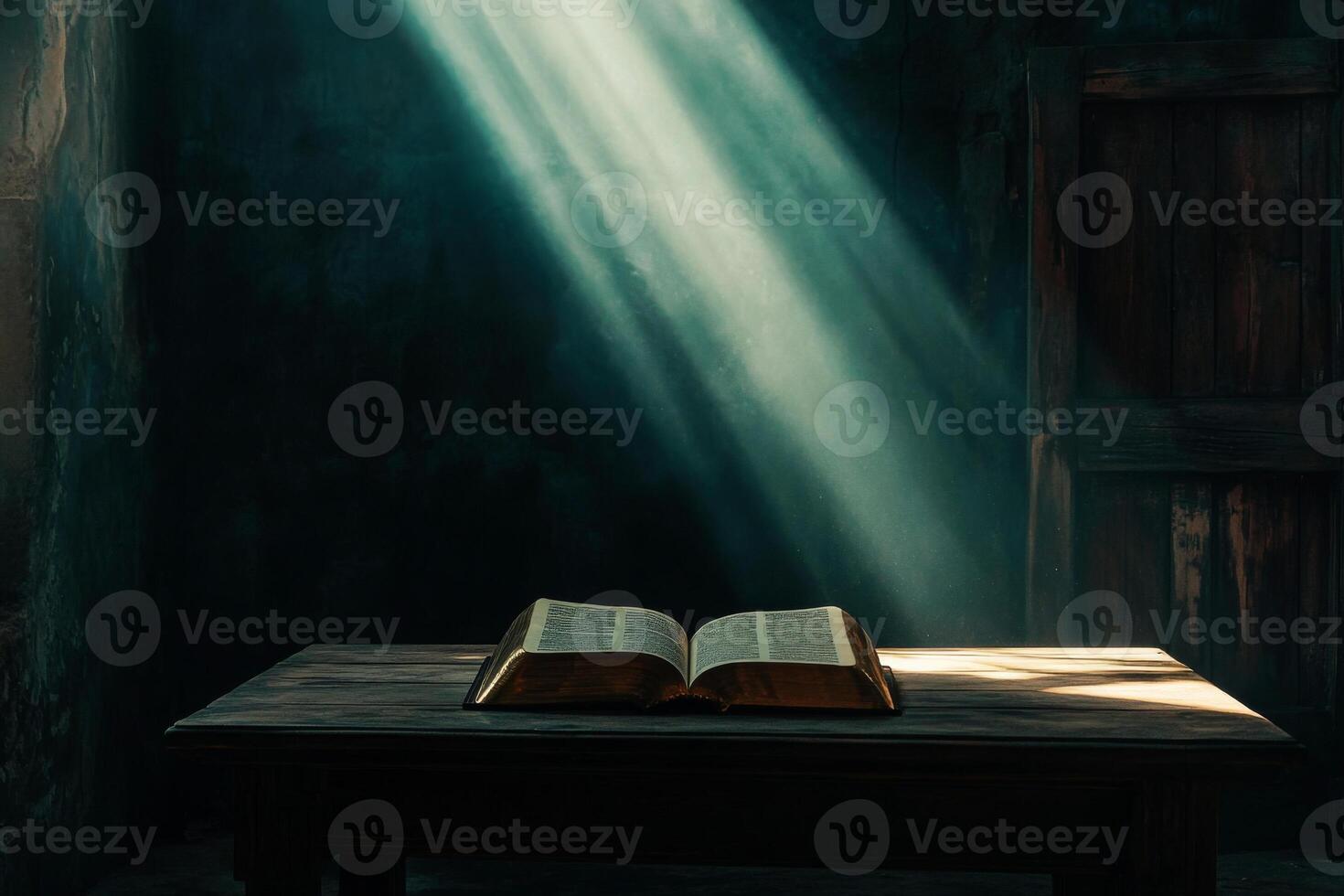 Open book illuminated by sunlight rays in dark room photo