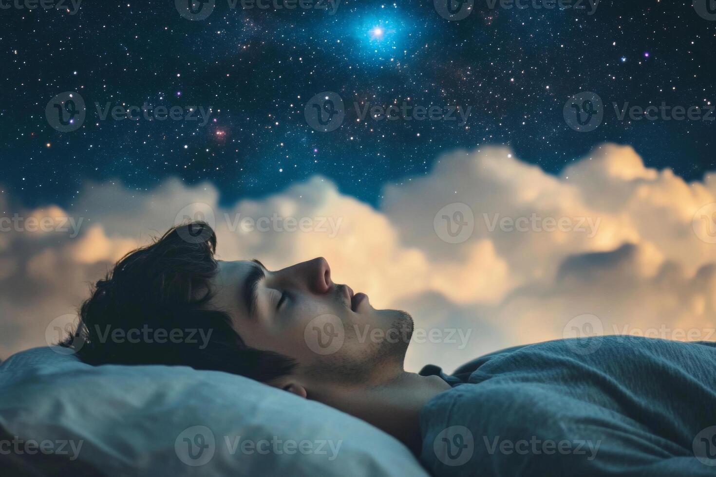 Young man sleeping on pillow under starry sky with clouds photo