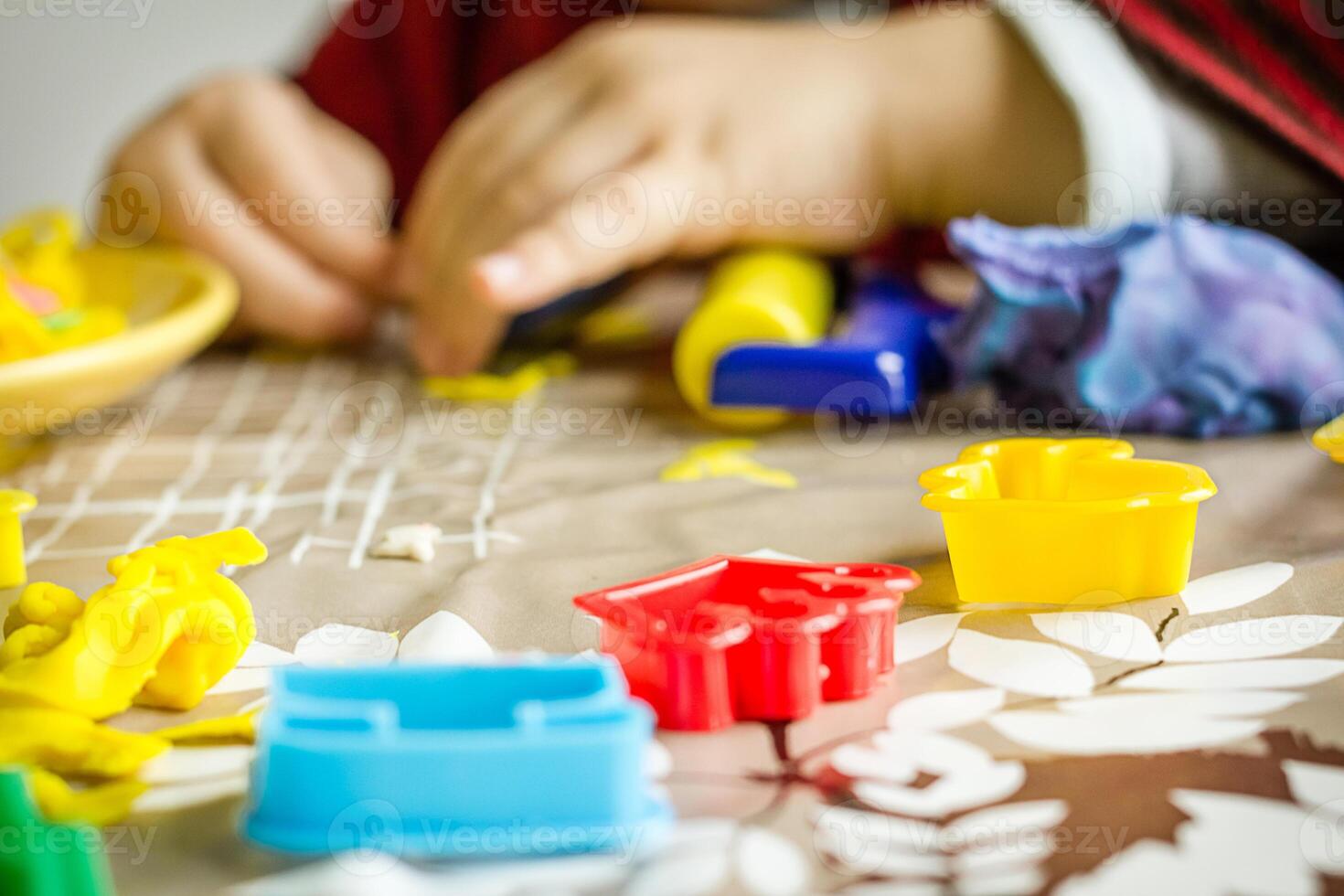 Detail of plasticine molds and child hands on the background photo