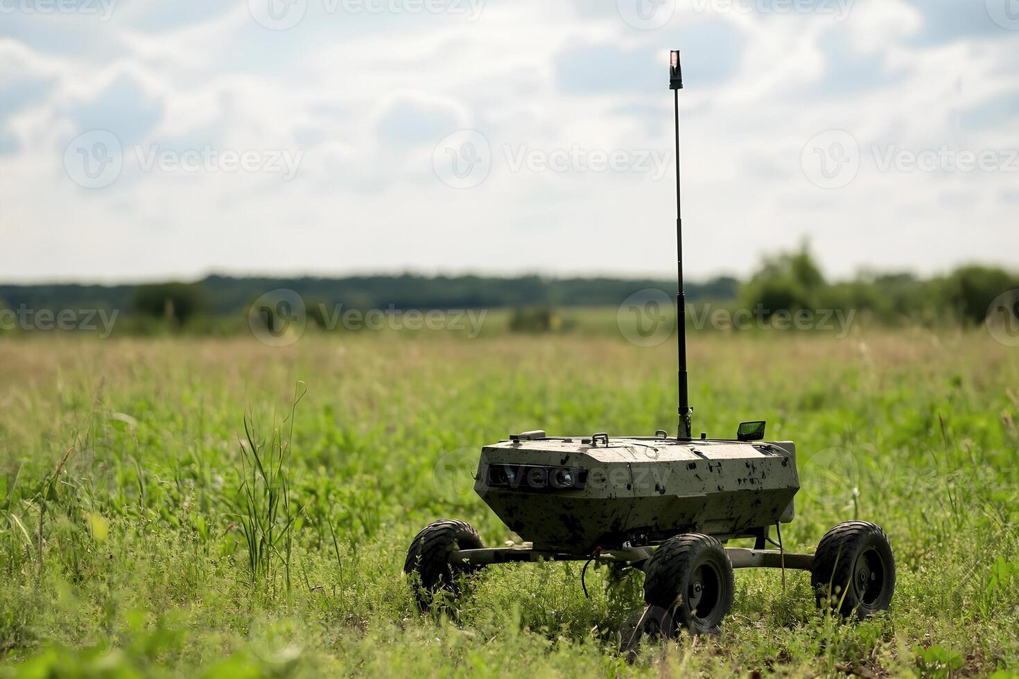 Military drone equipped with wheels and antenna in open field environment. photo