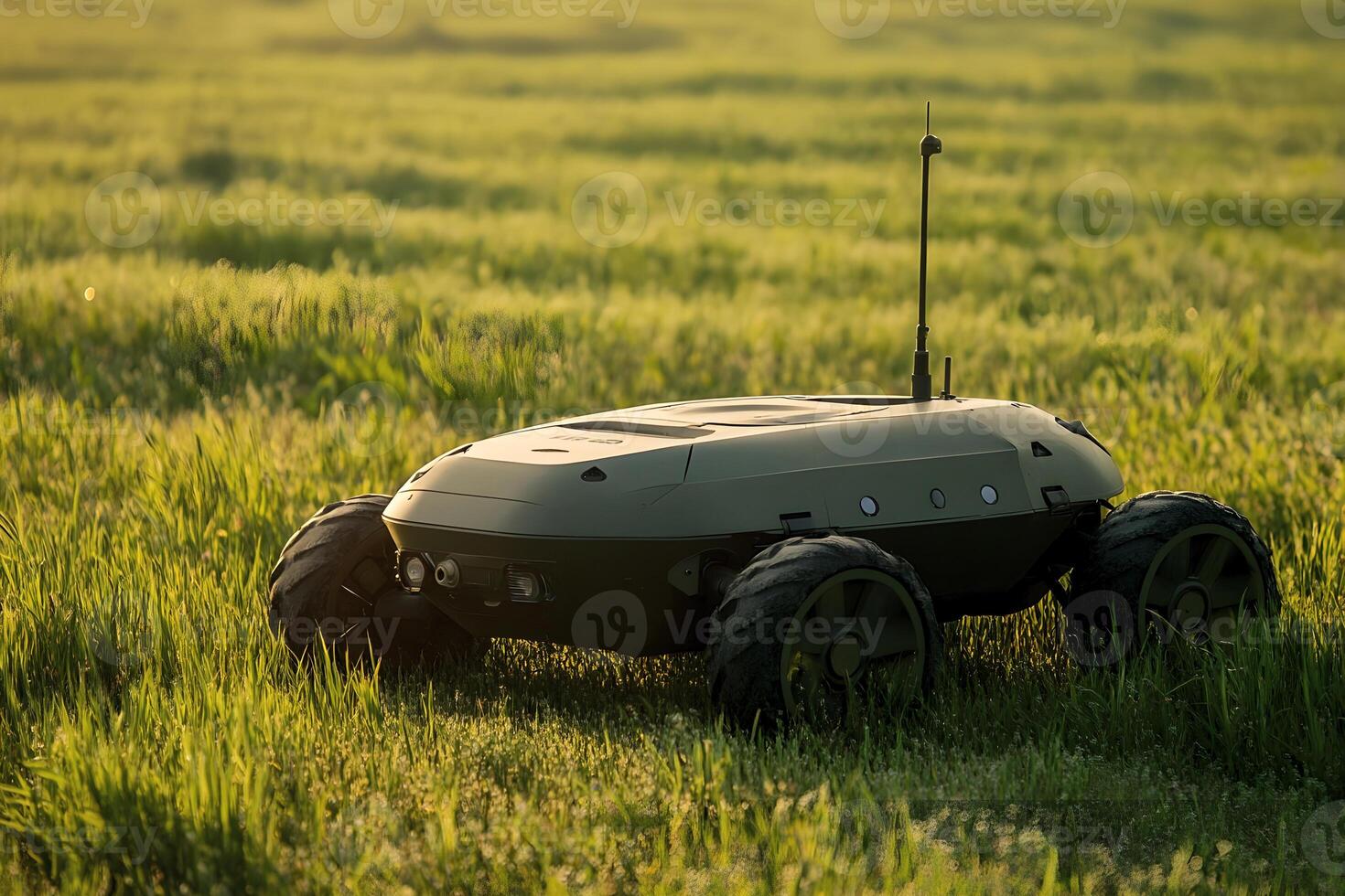 Advanced ground based military drone operates in grassy terrain during daylight. photo