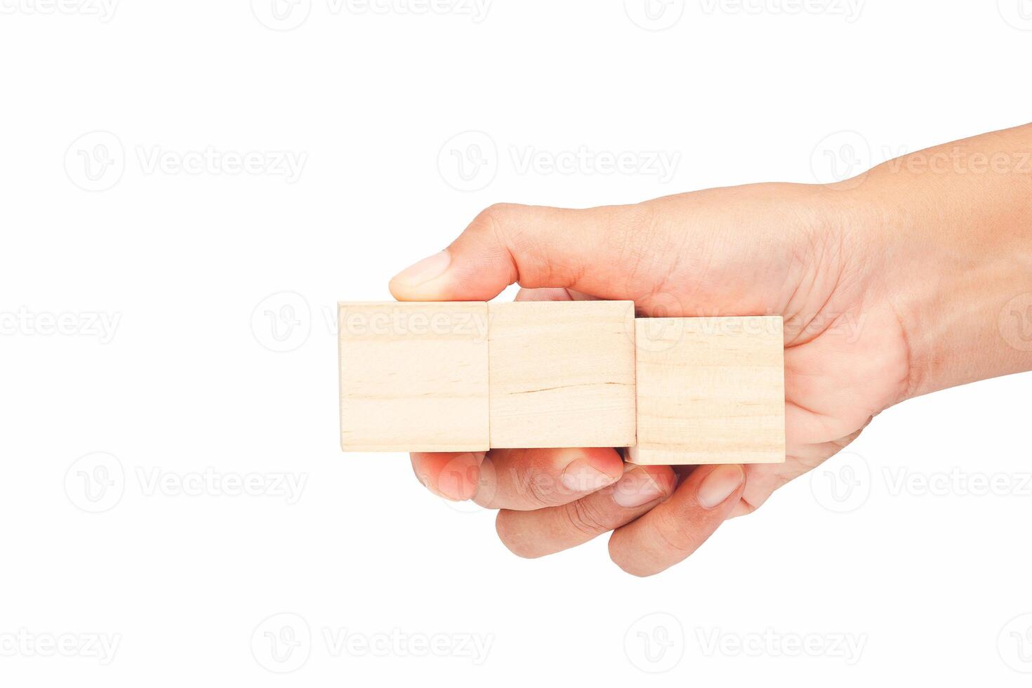 Empty wooden cubes in a hand with a white background photo
