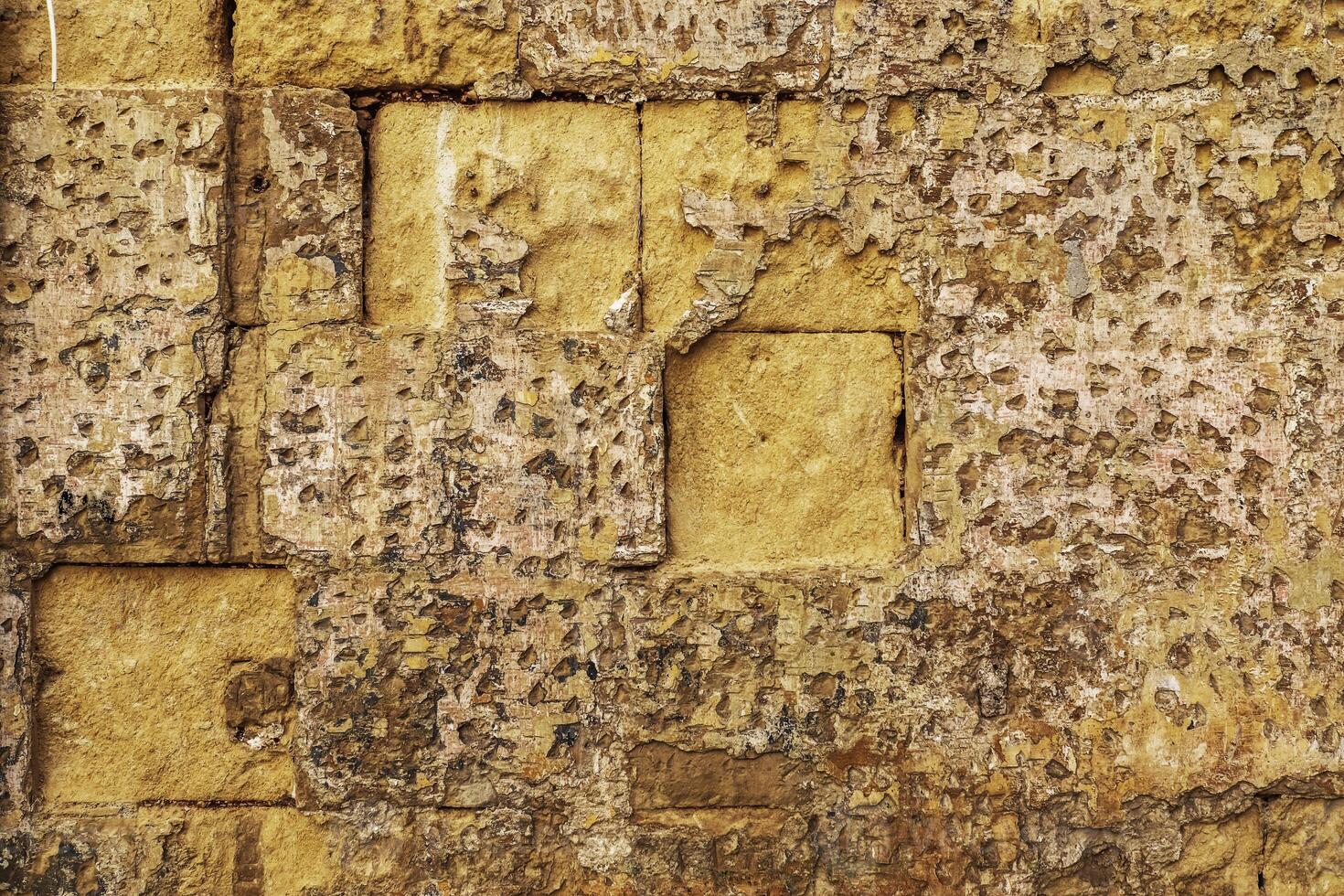 The patina of time on a stone wall in Maltas historic alleyways. photo