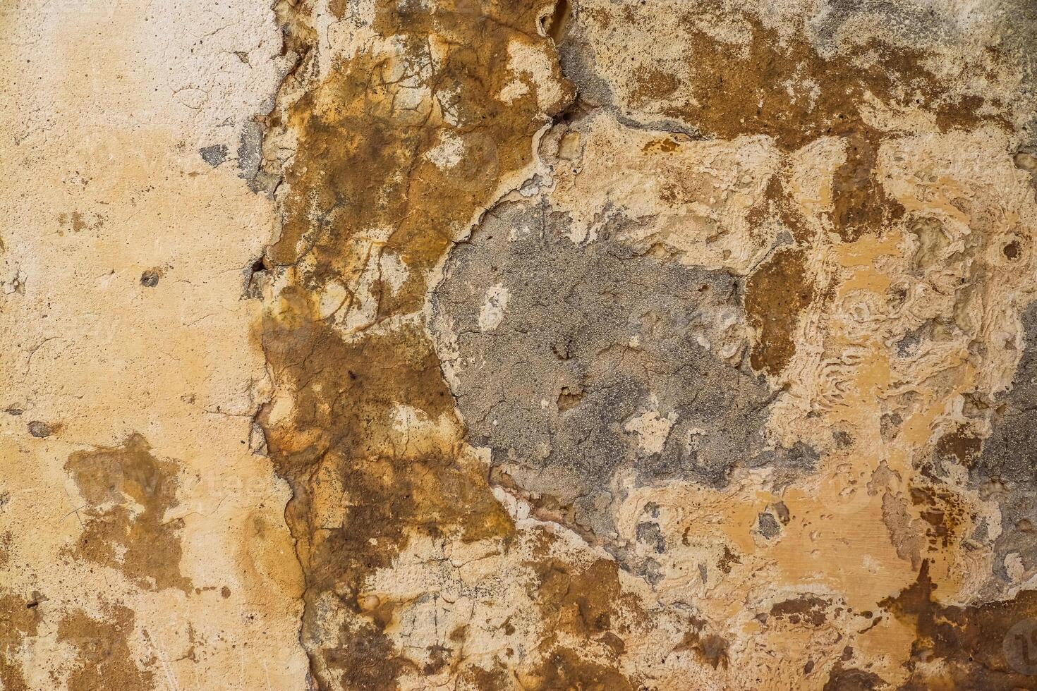 A close-up of a weathered stone wall in Malta's timeless alleys. photo