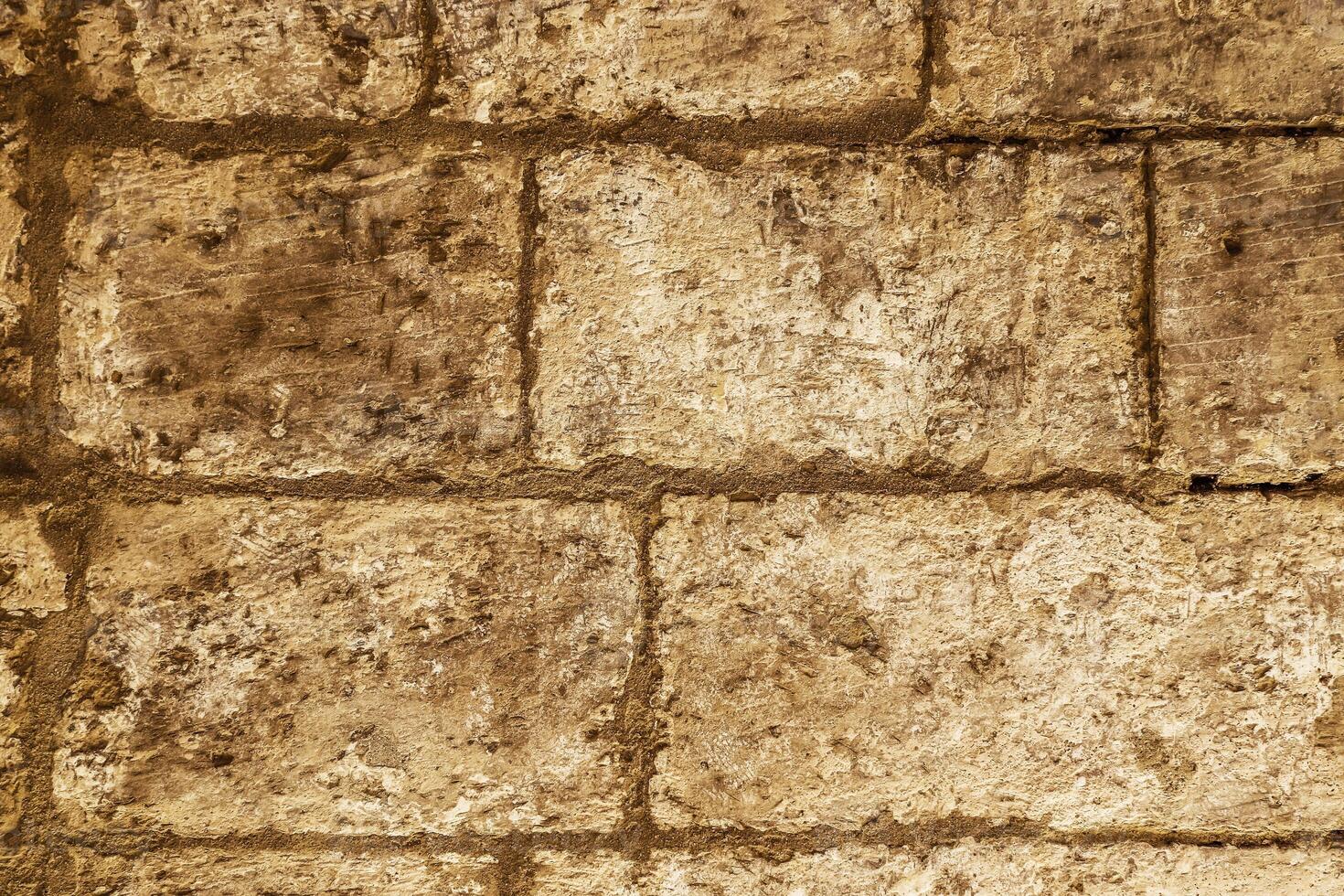 The rustic surface of a stone wall lining Malta's historic passageways. photo