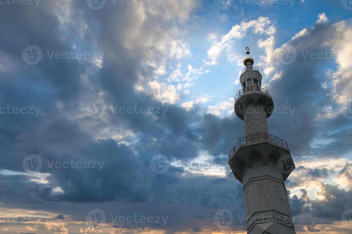 Sheikh Zayed Grand Mosque Minaret Tower Against a Blue Sky with Soft Clouds photo