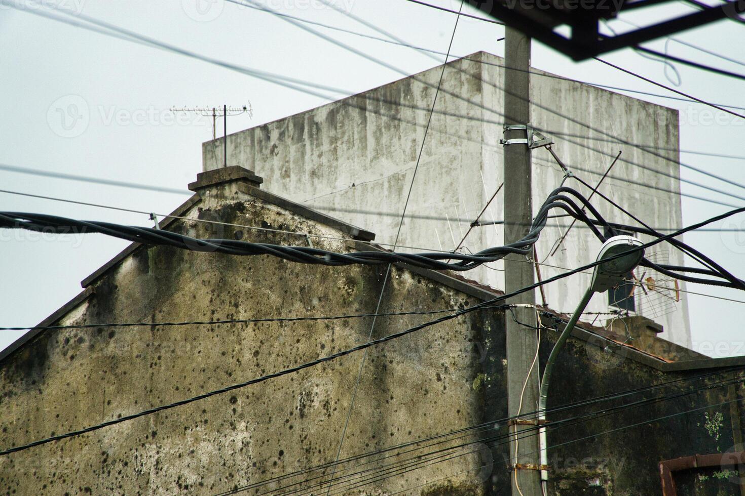 Urban Aesthetic Featuring Weathered Wall and Intersecting Overhead Wiring photo