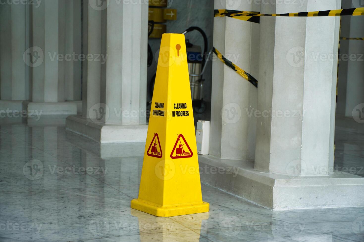Yellow Wet Floor Sign Displayed in a Clean Polished Interior Space photo