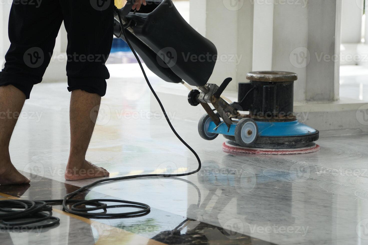 Janitor Polishing Marble Floor with Professional Equipment for Cleanliness photo