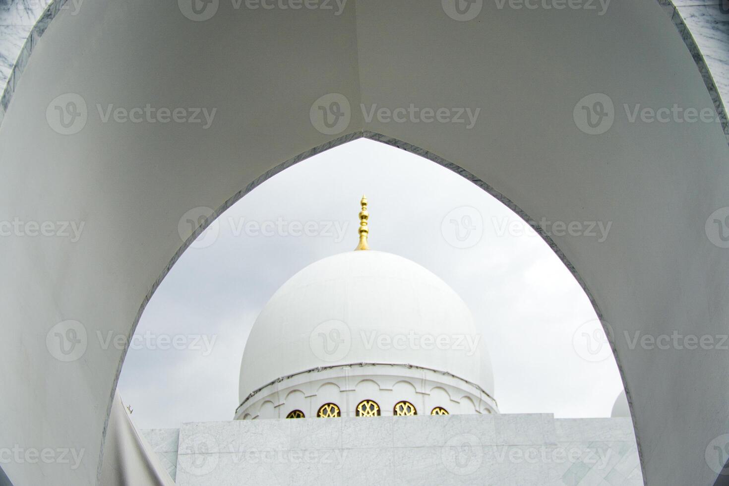 Architectural View of a Sheikh Zayed Grand Mosque Dome Through an Arched Window photo