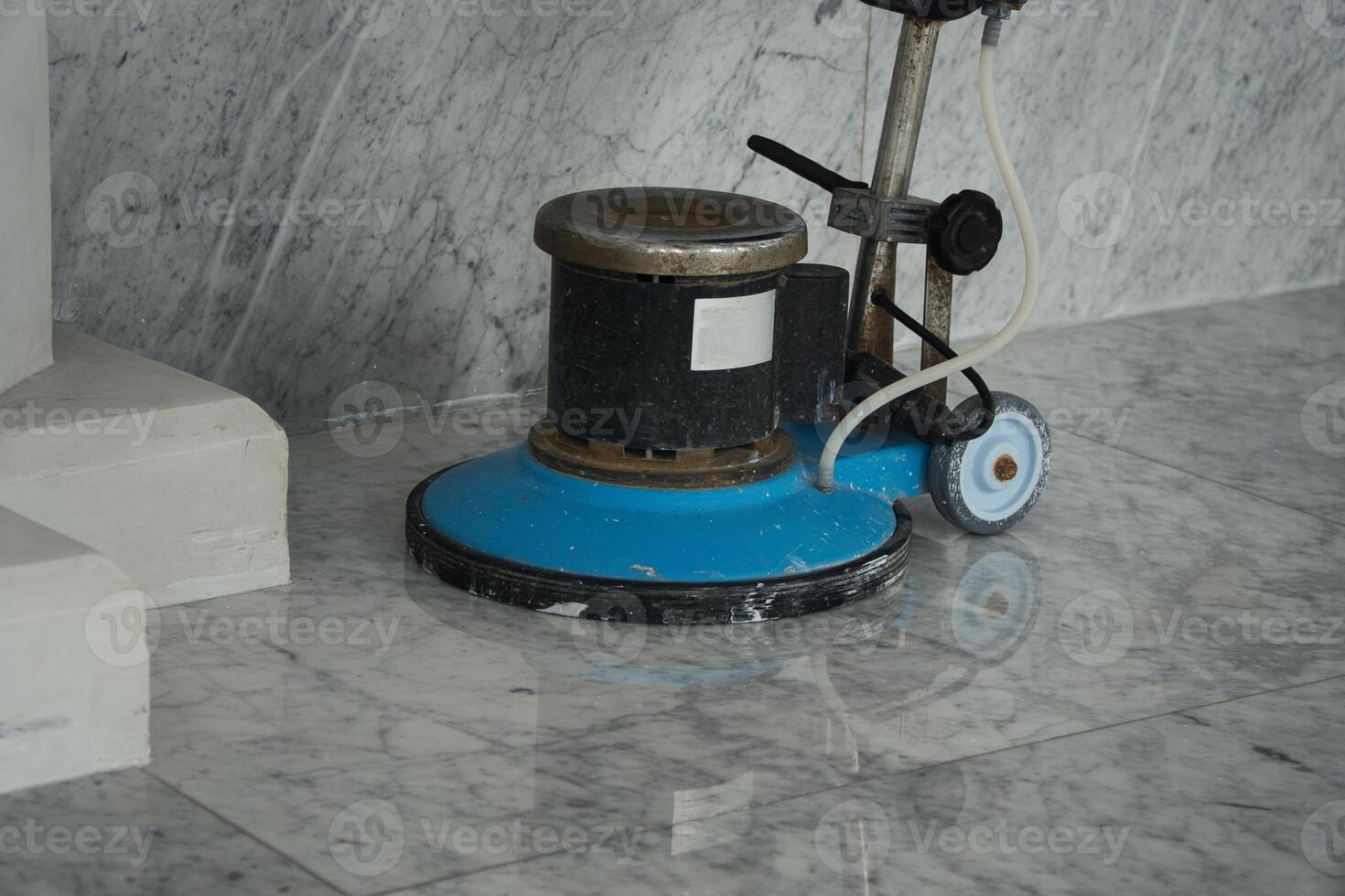 Floor Polishing Machine on Shiny Marble Floor for Cleaning and Maintenance photo