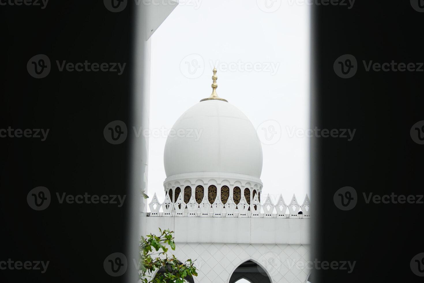 Sheikh Zayed Grand Mosque Dome Against Cloudy Sky Viewed Through Structure photo