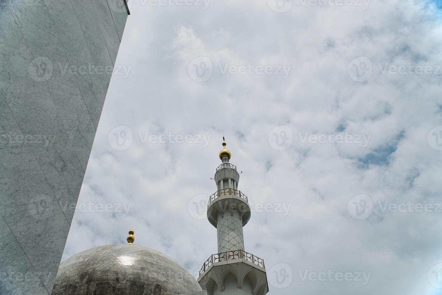 Islamic Elegant Sheikh Zayed Grand Mosque Architecture Featuring Dome and Minaret Against Cloudy Sky photo