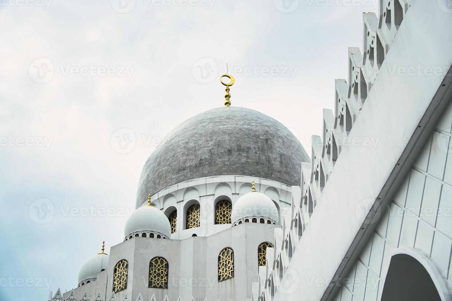 Majestic Dome of Sheikh Zayed Grand Mosque in Front of a Dramatic Cloudy Sky photo