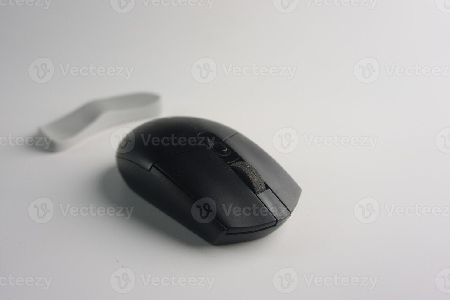 Black Modern Wireless Computer Mouse Placed On White Background Surface photo