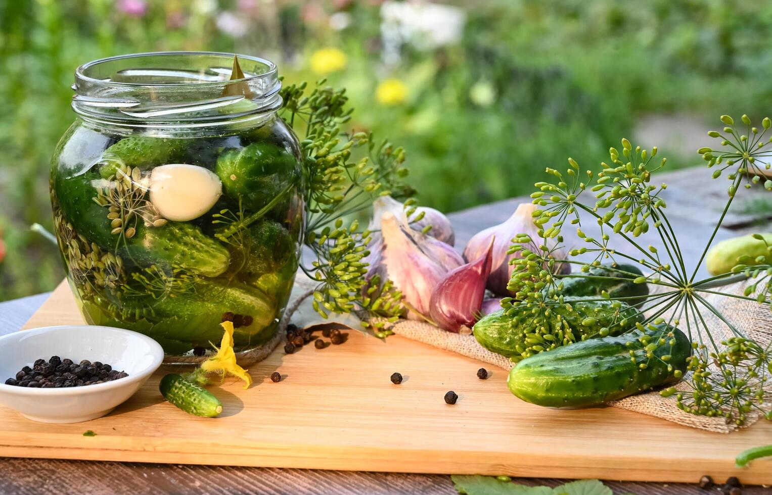 a set of ingredients for pickling cucumbers, pickled cucumbers, brine On a beautiful day. photo