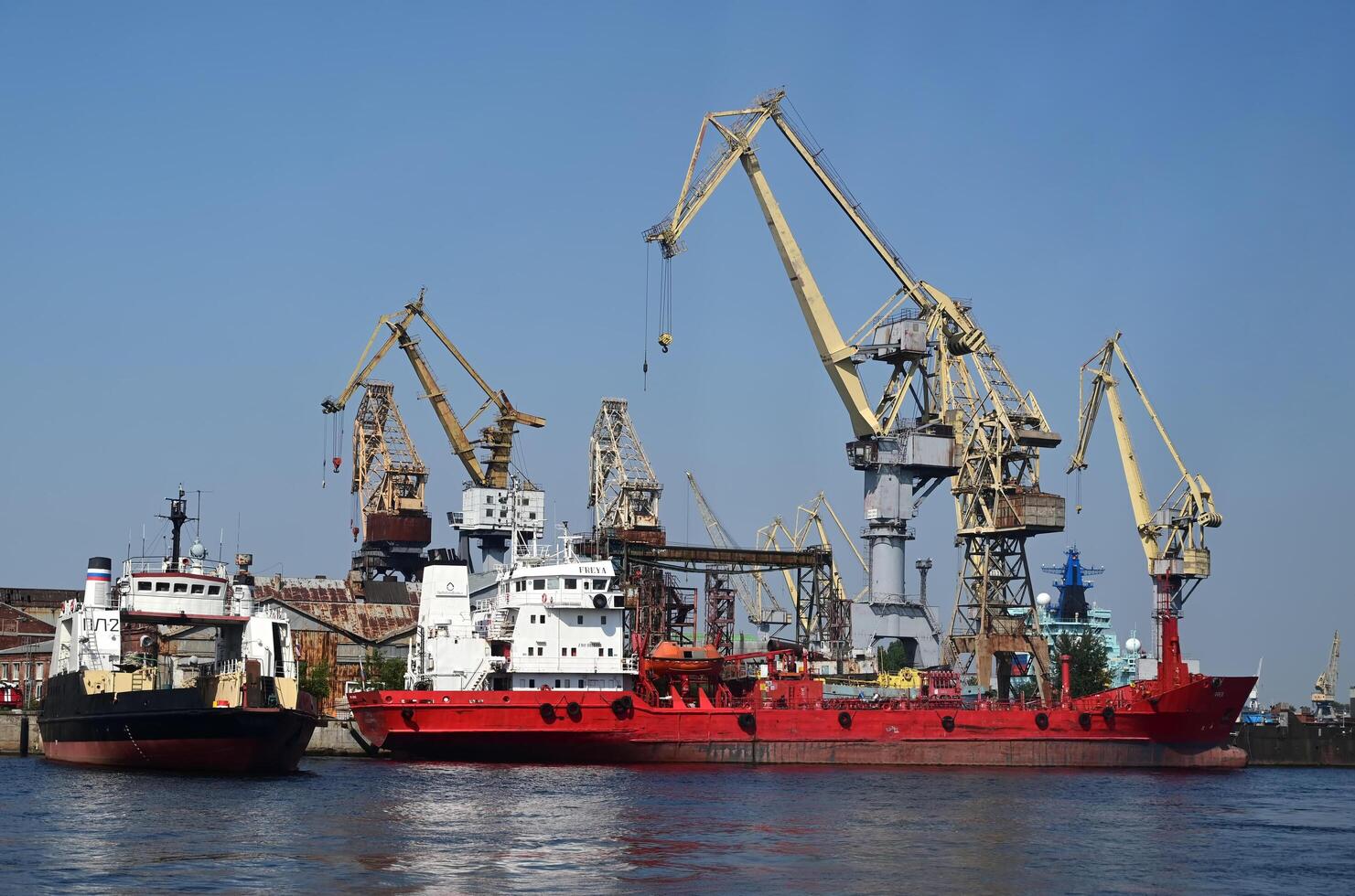 Working cranes in the port city on a shunny day photo