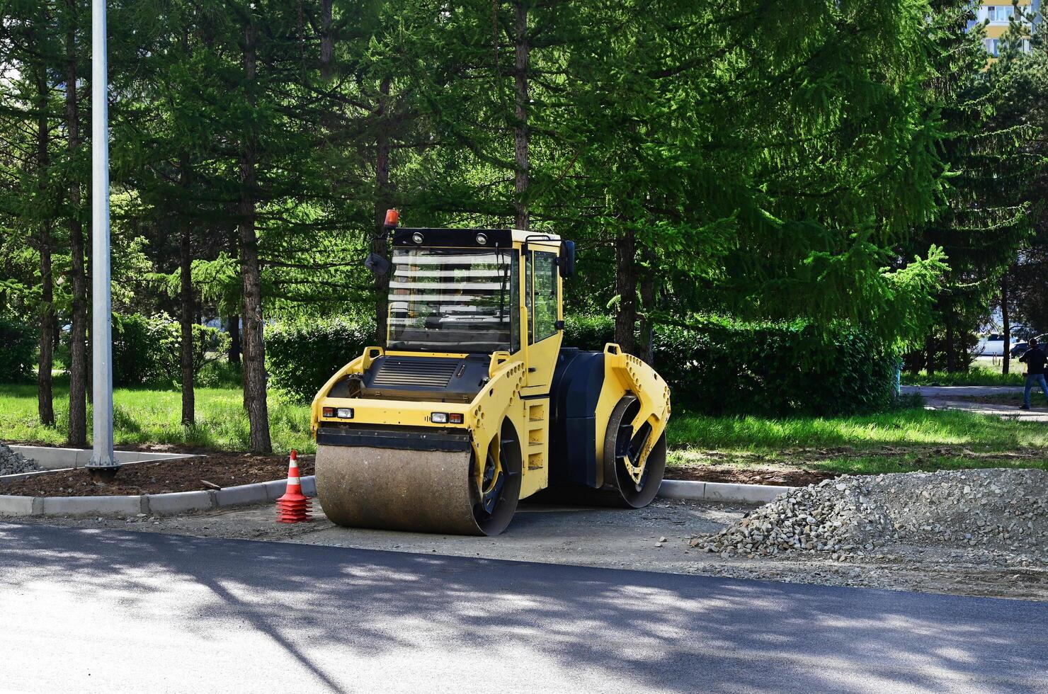 Large view on the road rollers working on the new road on a shunny day photo