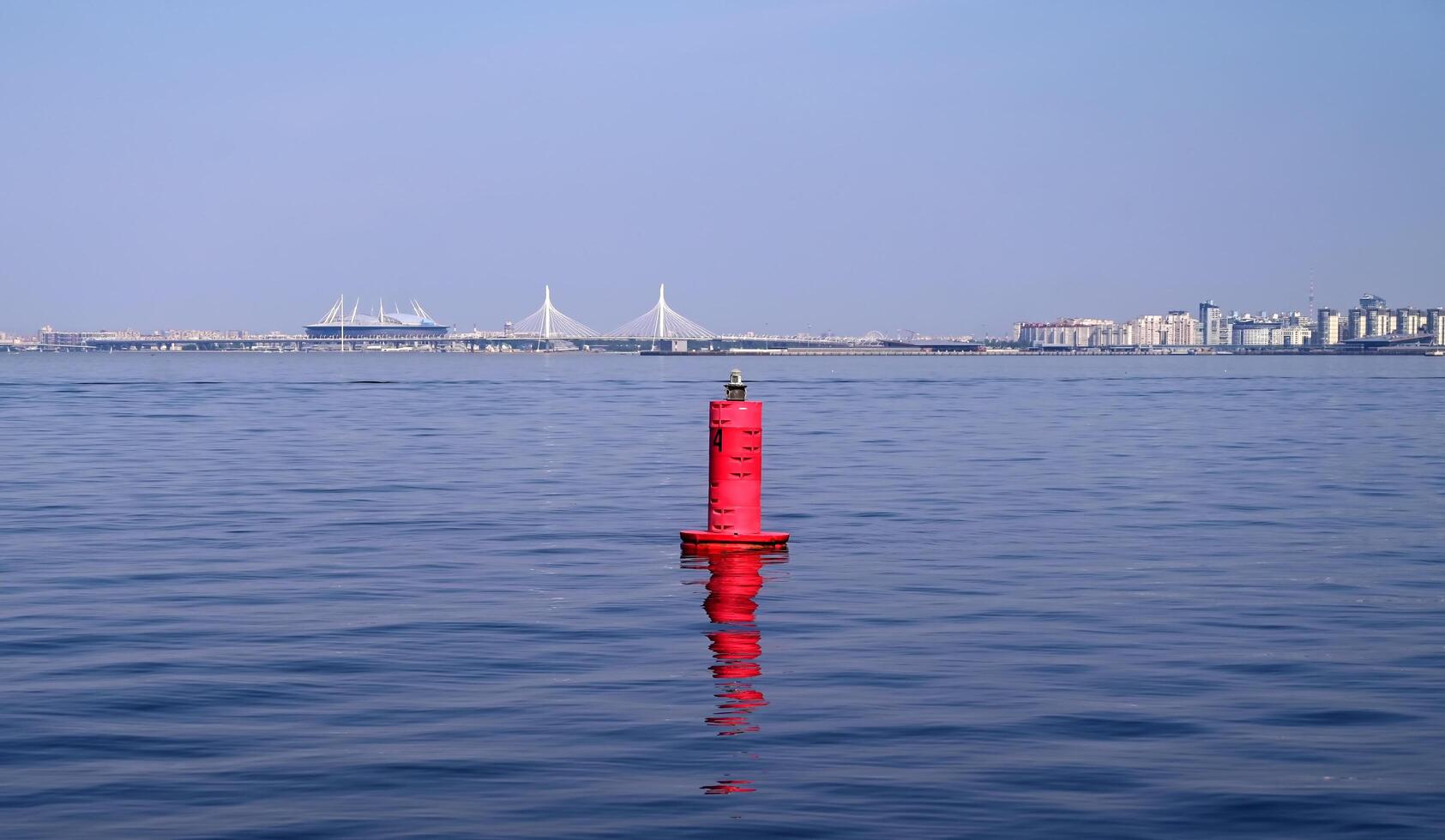 Signal buoy in the river near the city photo