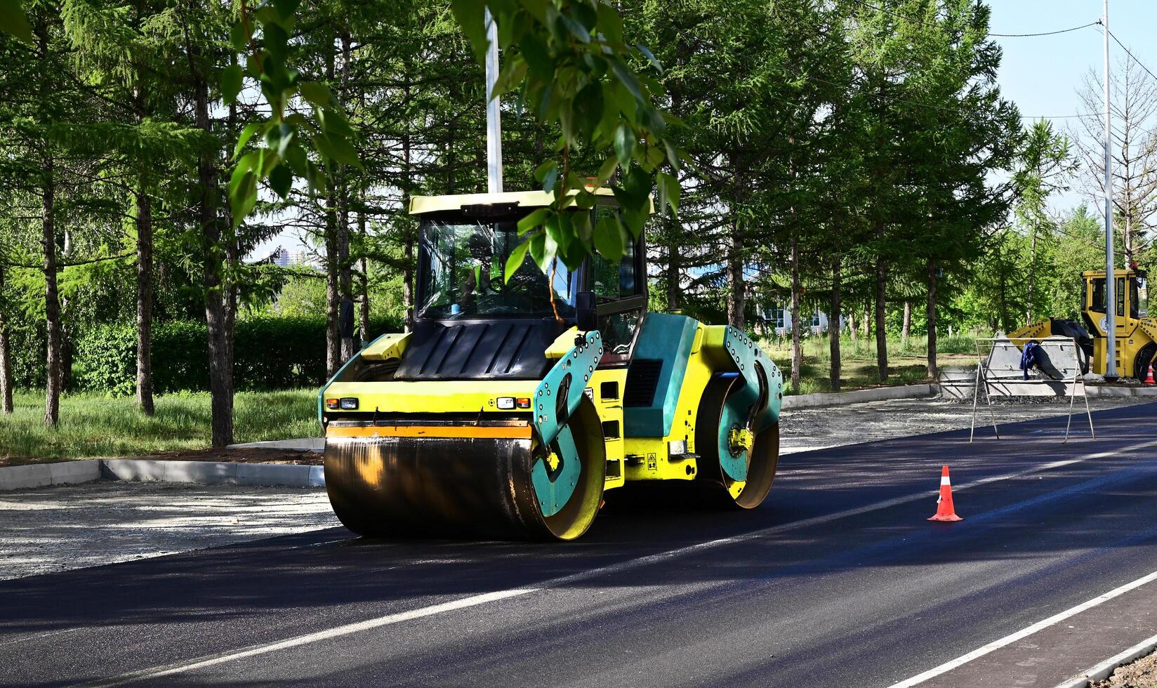 Large view on the road rollers working on the new road construction site on a shunny day photo