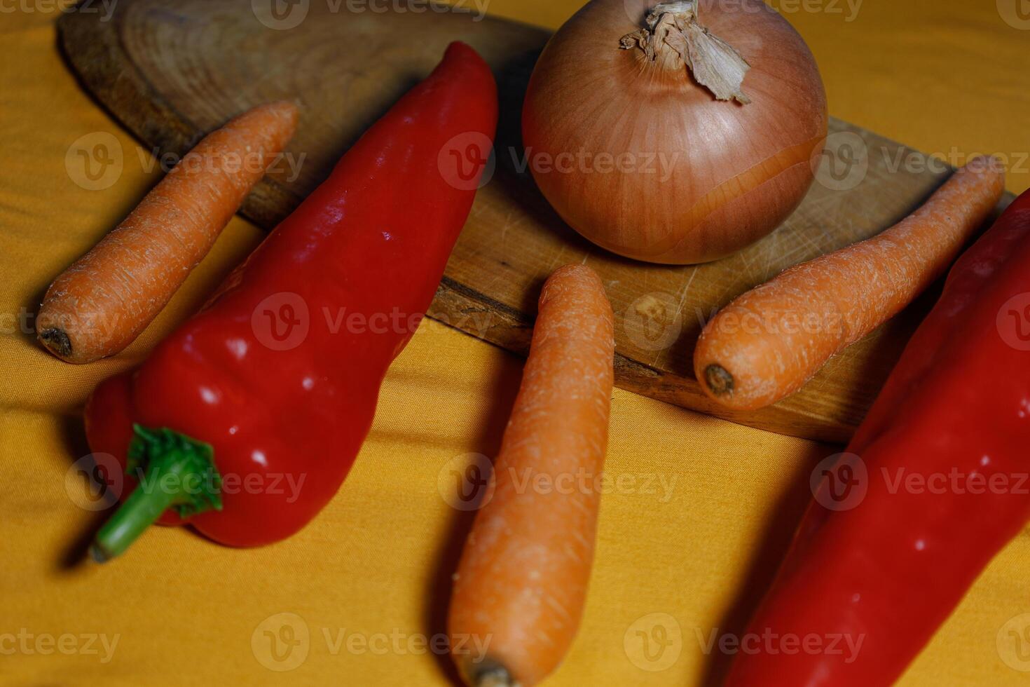 A selection of vegetables on a yellow surface. photo