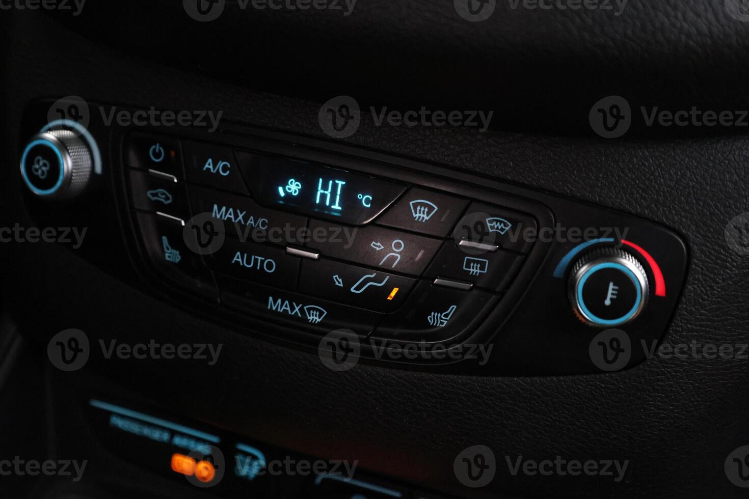 Car black interior dashboard with temperature, adjustment of the blower, air conditioner and other buttons photo