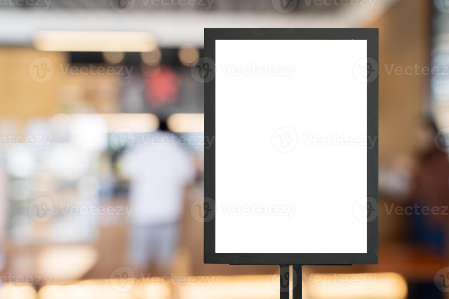 Mockup white poster with black frame stand in front of blur restaurant cafe background for show or present photo
