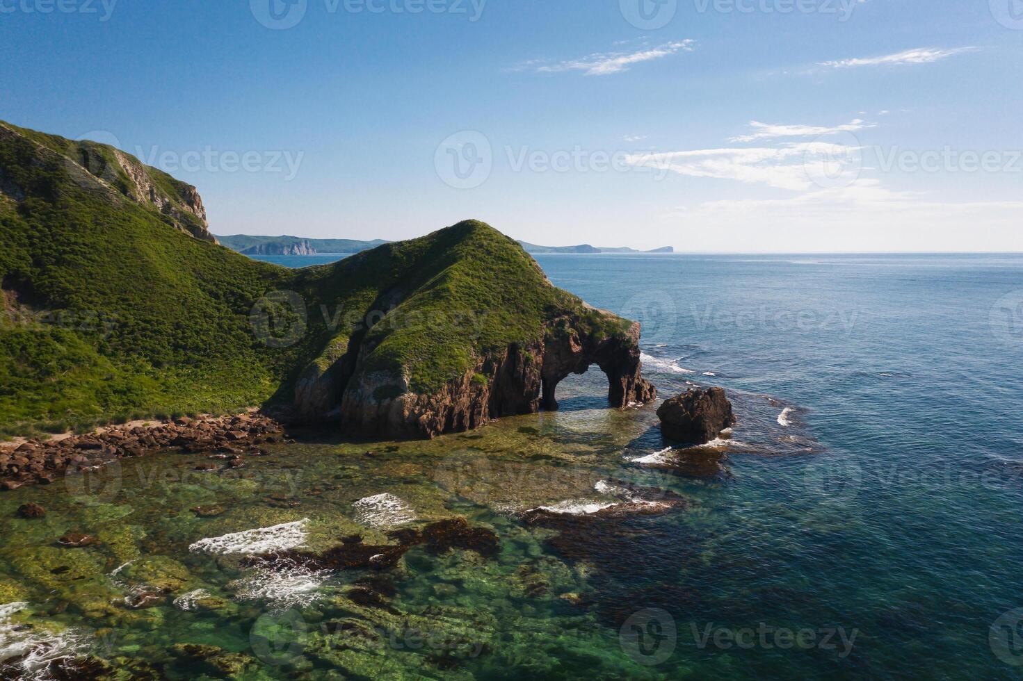 Drone view of an elephant-like natural stone arch on the seashore photo