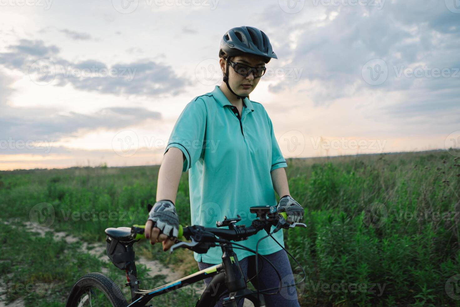 Woman Riding a Mountain Bike on a Dirt Path Near Suburbia photo