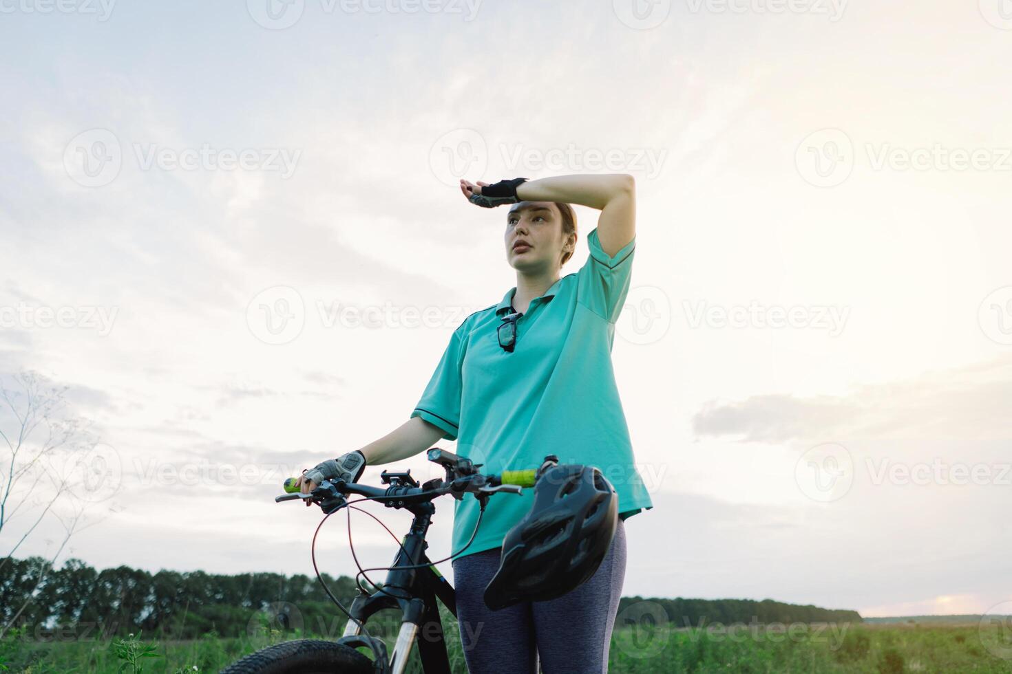 Woman in Blue Shirt Resting After Cycling photo