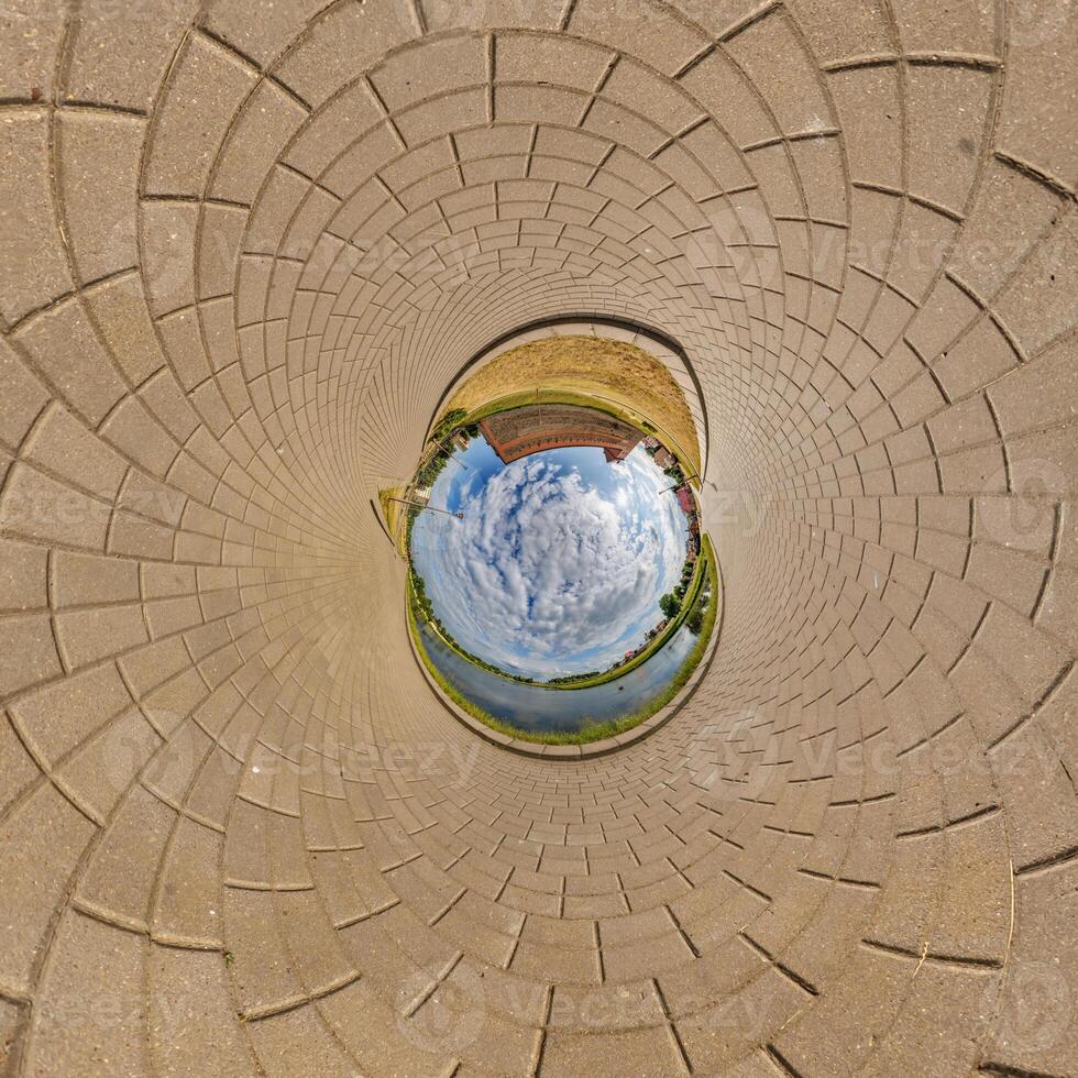 blue sphere inside old town, urban development, historic buildings surrounded by a frame of paving slabs. Transformation of spherical 360 panorama in abstract aerial view. photo