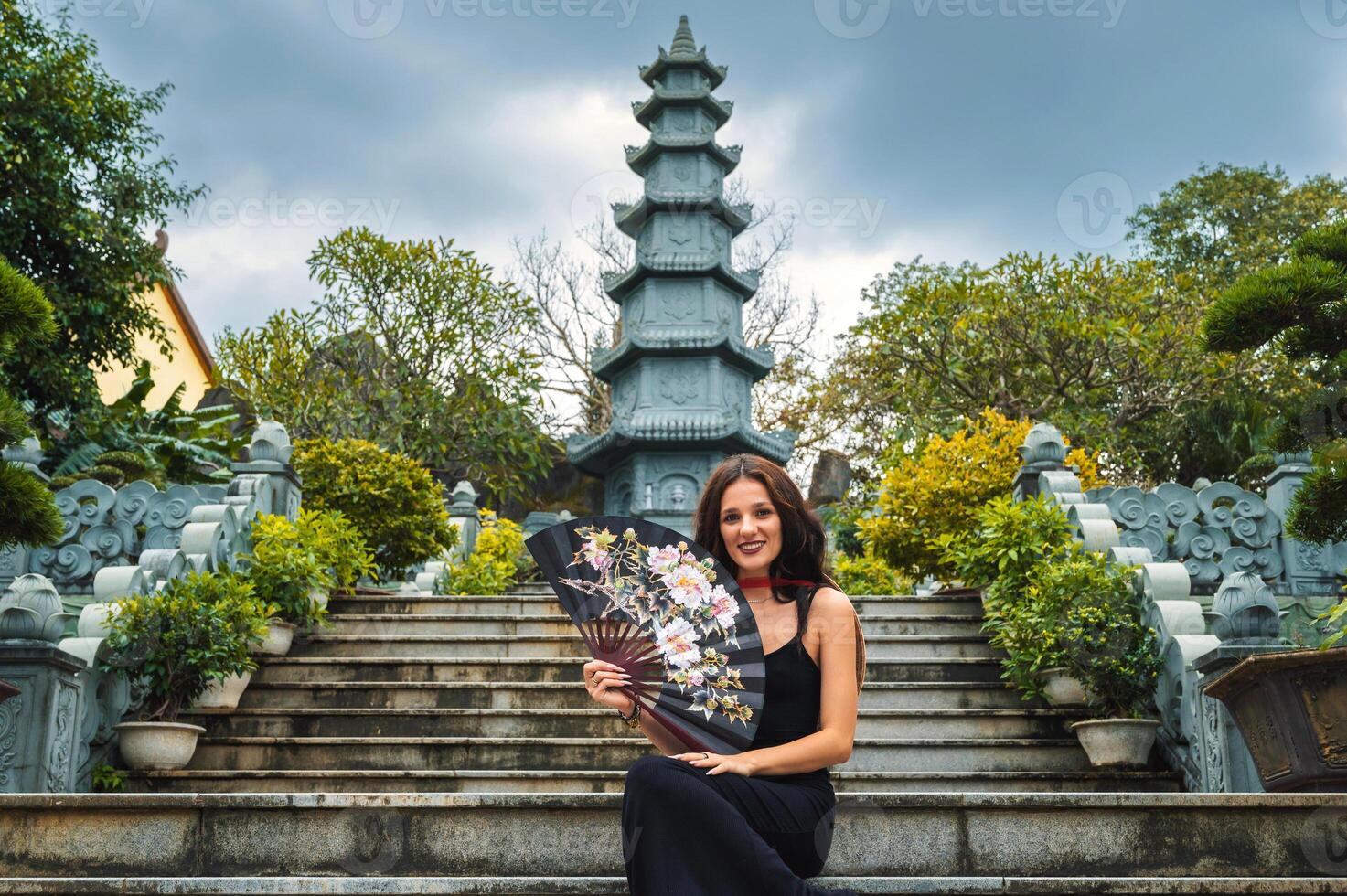 A female tourist on the background of the tower of the Buddhist temple in the Linh Un pagoda in Da Nang in Vietnam in Asia photo