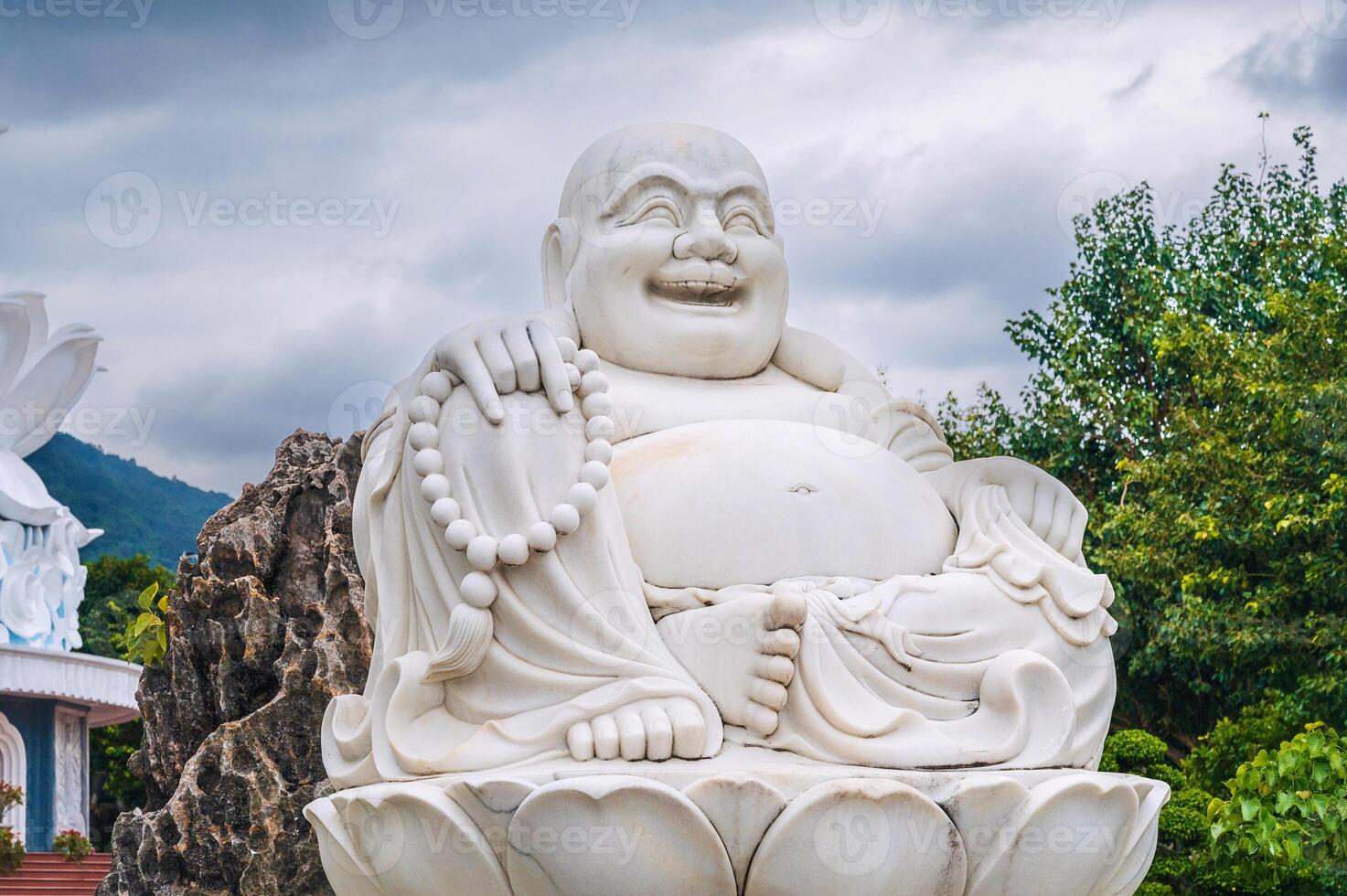 White statue of the happy Buddhist god Hotei at Linh Ung Pagoda in Da Nang in Vietnam in Asia photo