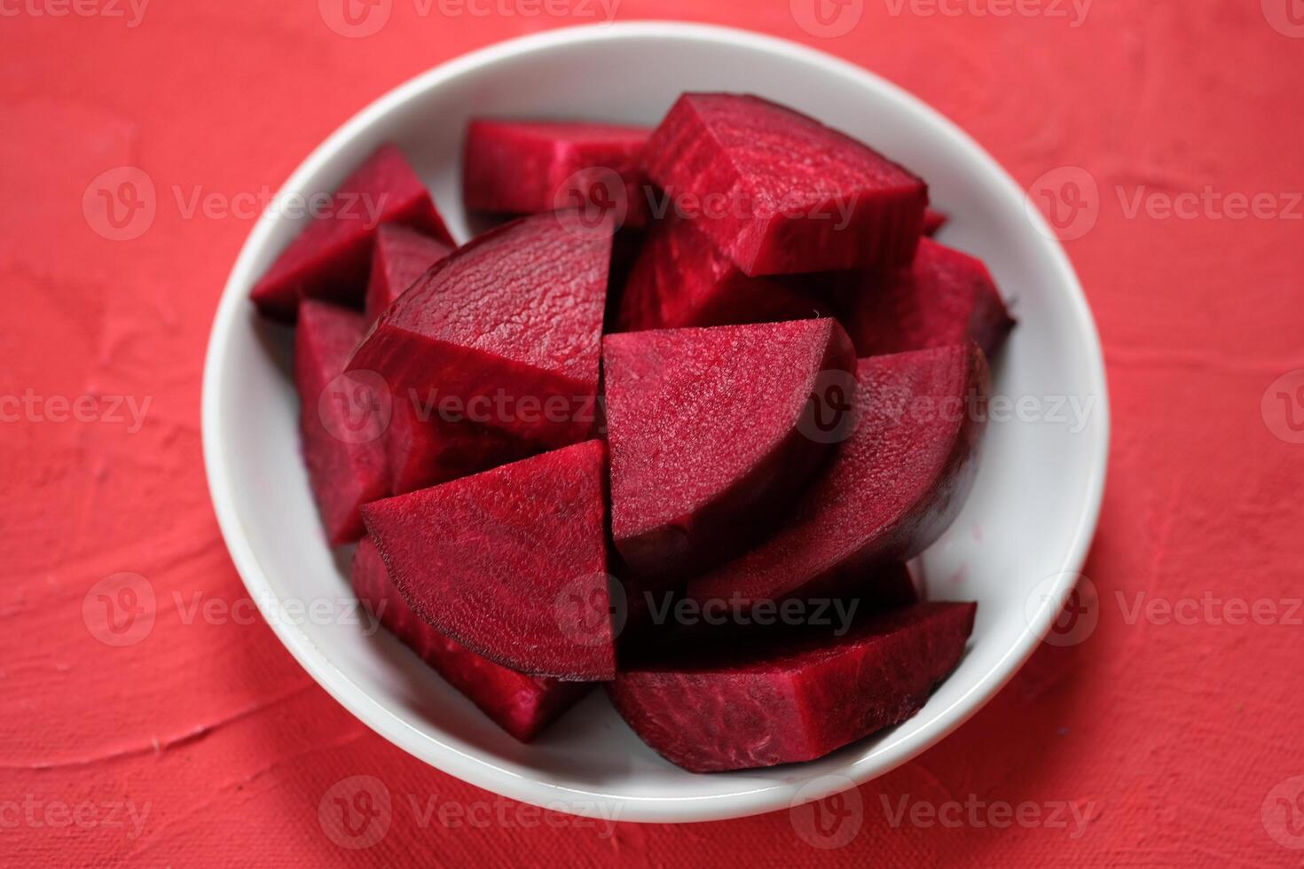 Beta vulgaris. sliced beetroot on a white plate. golden beet or red beet. red vegetables. photo