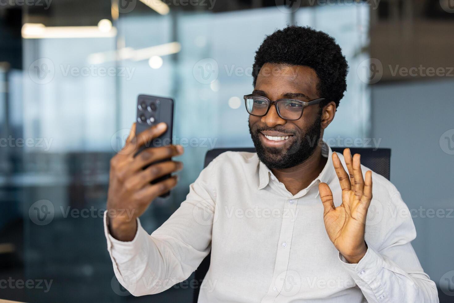 Businessman using phone for call, young office worker at workplace inside office using app on smartphone, communicating with friends and colleagues remotely. photo