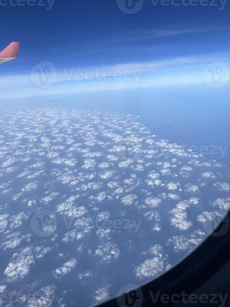 Cloud patterns that can be observed from the window of an airplane during flight travel photo
